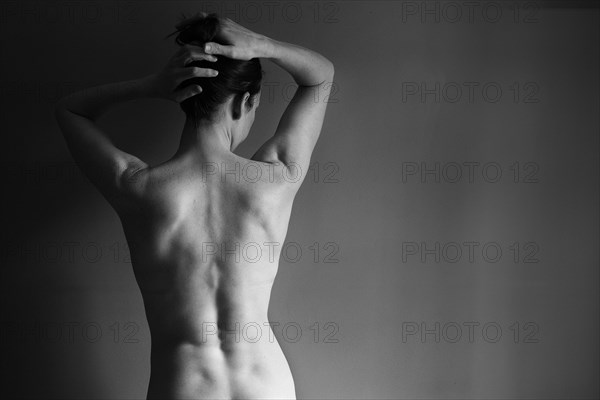 Muscular back of nude Caucasian woman