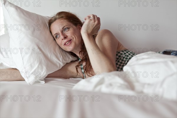 Caucasian woman laying in bed