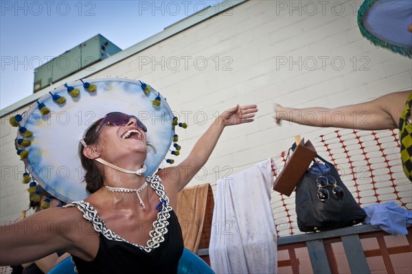 Dancing woman wearing sombrero outdoors