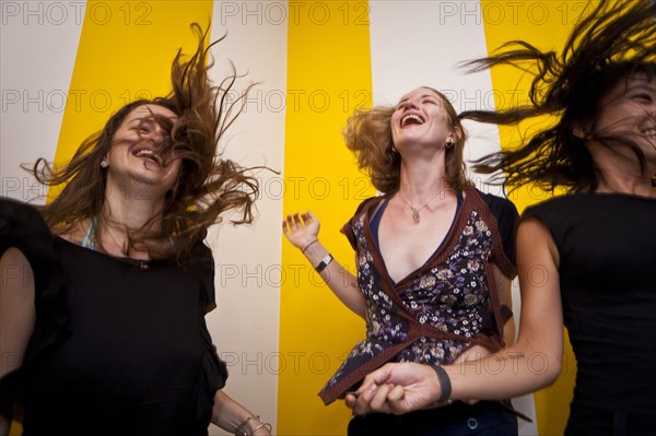 Low angle view of smiling women dancing