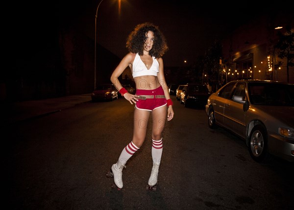 Woman wearing roller skating costume at night