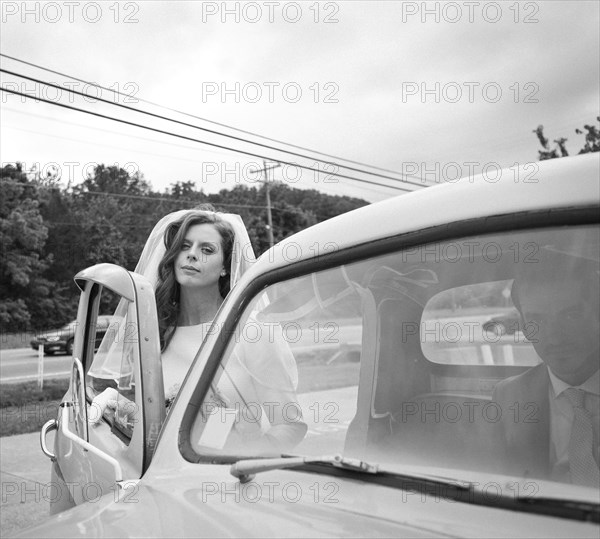 Bride climbing into vintage truck