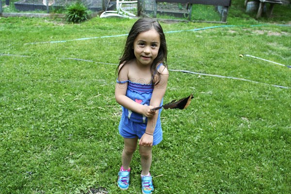 Caucasian girl playing in backyard