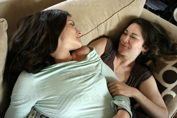 Smiling women relaxing on sofa