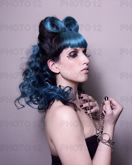 Close up of stylish woman with dyed hair and jewelry