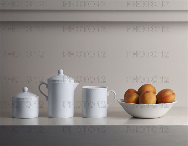 Bowl of fresh fruit and white pitchers