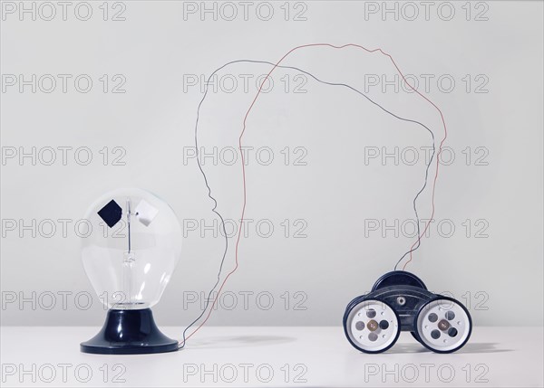 Wire connecting toy car to light bulb