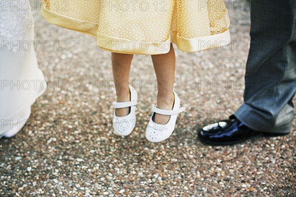 Close up of flower girl jumping for joy