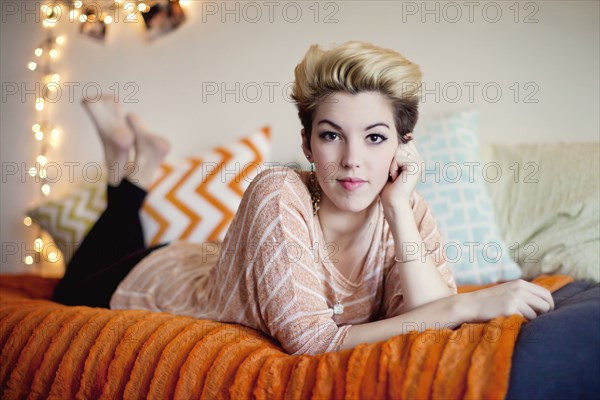 Smiling woman laying on bed