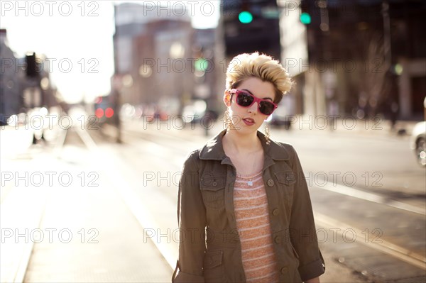 Woman standing in city intersection