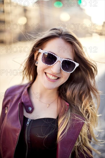 Woman wearing sunglasses in city