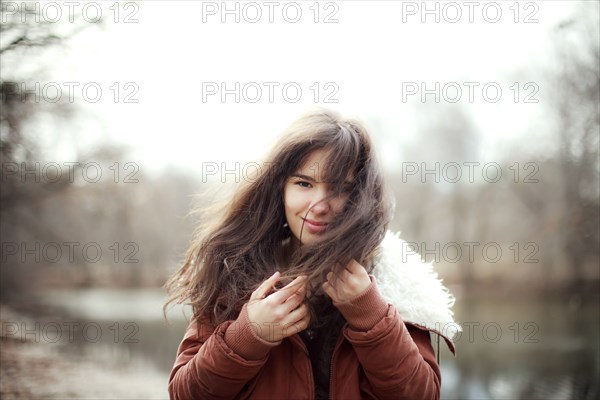 Caucasian woman wearing furry coat outdoors