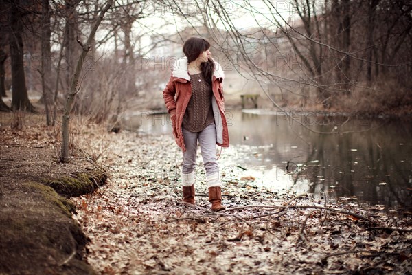 Caucasian woman walking near rural creek