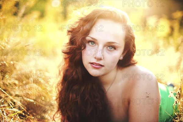 Close up of woman laying in tall grass