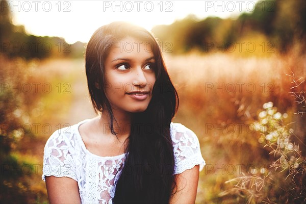 Smiling woman in rural field