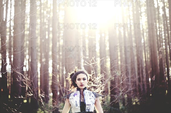 Close up of woman standing under trees