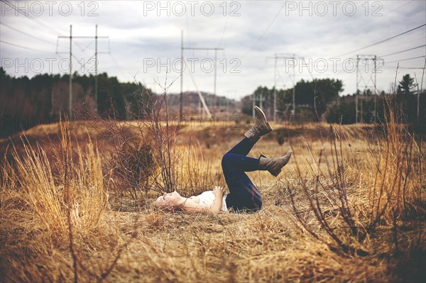 Girl laying on back in field