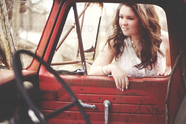 Woman examining vintage truck interior