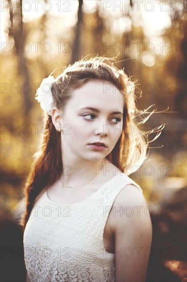 Caucasian teenage girl standing in forest