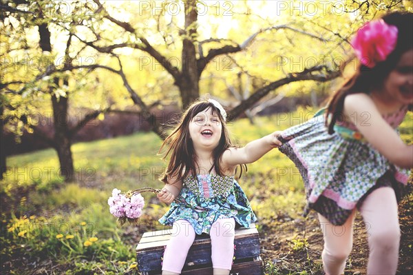 Smiling girls playing in orchard