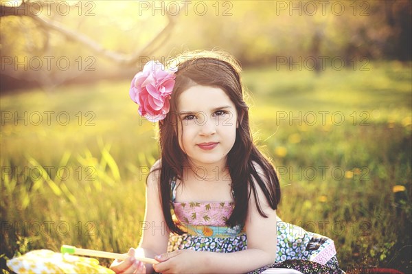 Girl playing with pinwheel in rural field