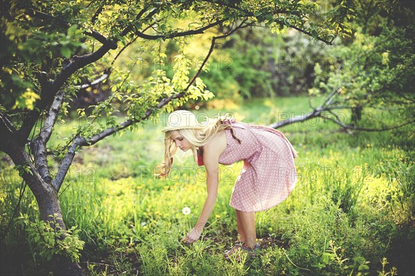 Woman picking flowers in rural field