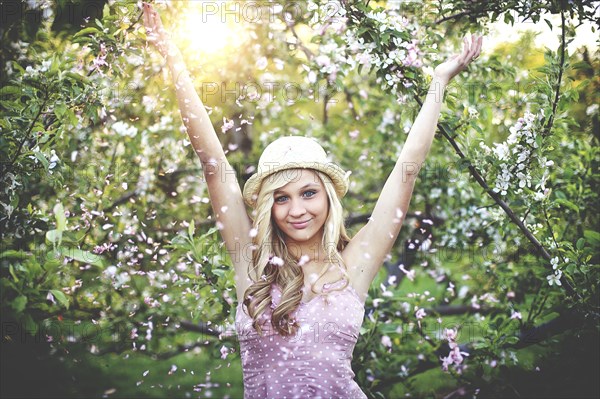 Woman standing in flowering trees