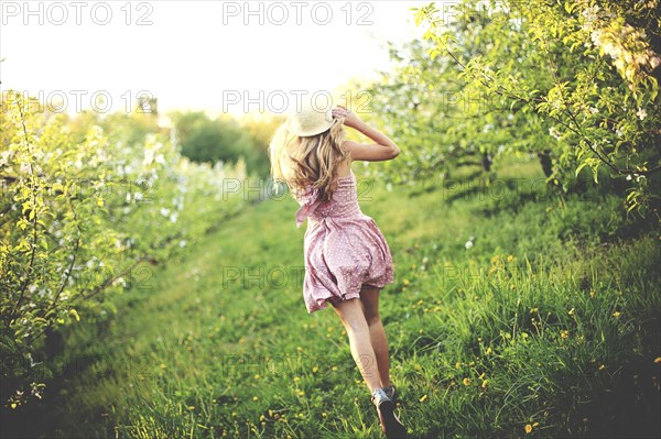 Woman walking in rural orchard