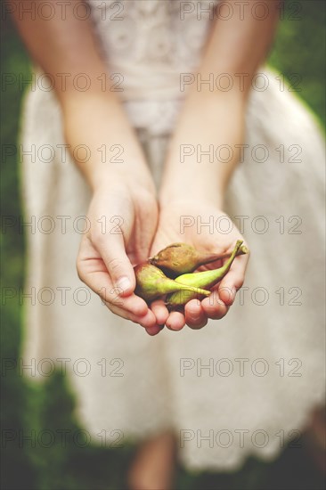 Close up of woman girl seed pods