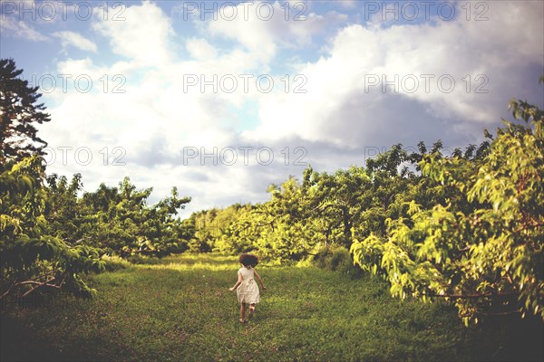 Girl running in rural field