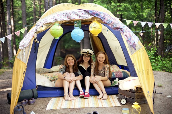 Girls relaxing in camping tent