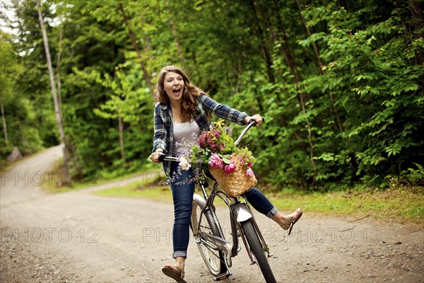 Girl riding bicycle on dirt path