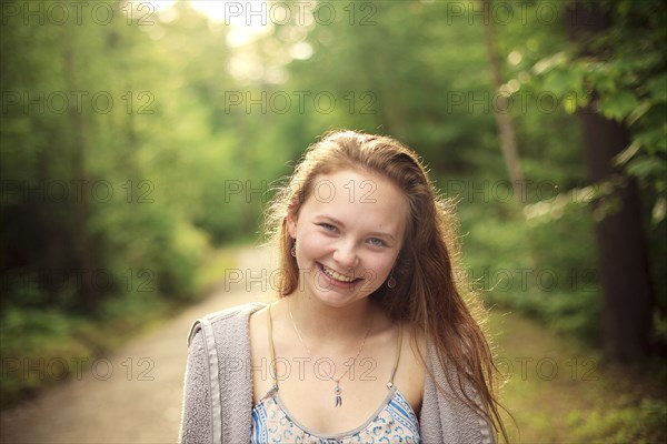 Caucasian girl smiling on forest path