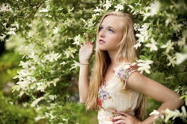 Woman standing under flowering tree