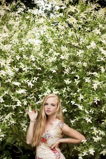 Woman standing under flowering tree