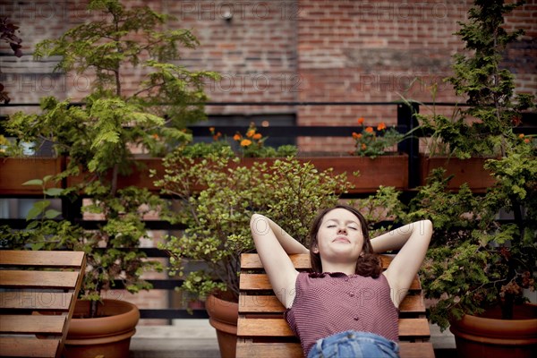 Teenage girl relaxing on urban rooftop