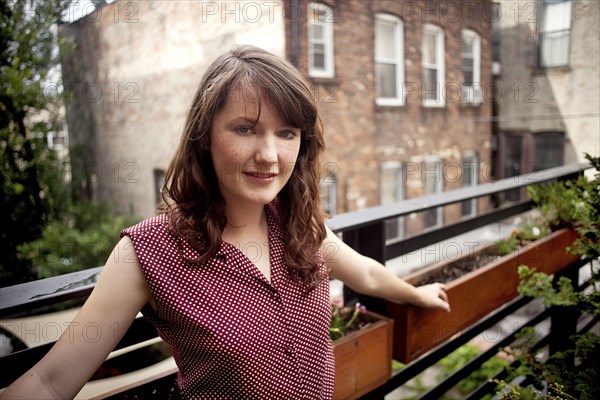 Teenage girl standing on urban rooftop