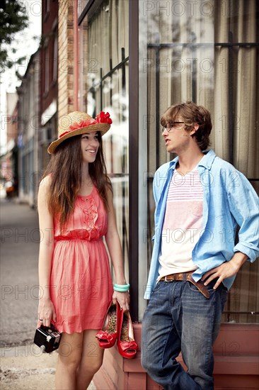 Couple talking on city sidewalk