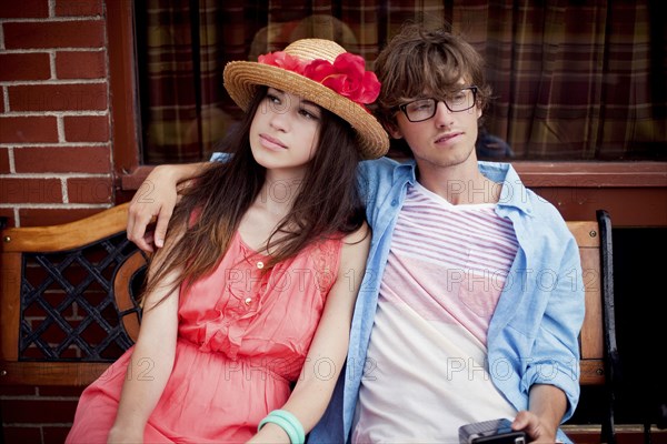 Serious couple sitting on bench