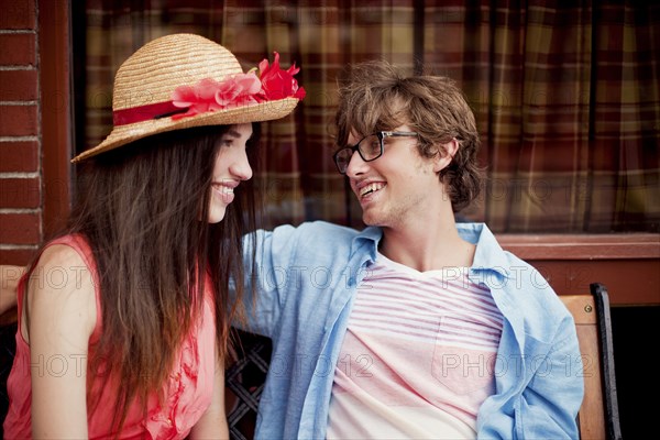 Laughing couple sitting on bench