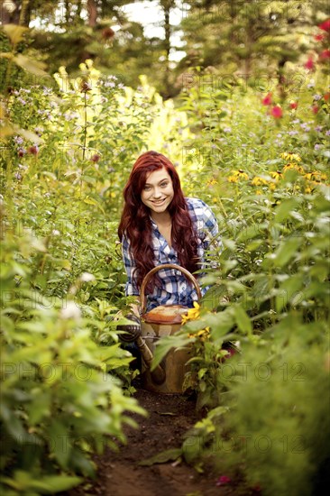 Gardener weeding plants in backyard