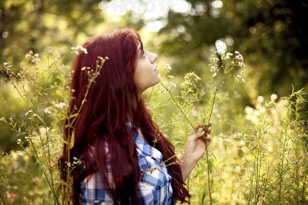 Girl standing in tall grass