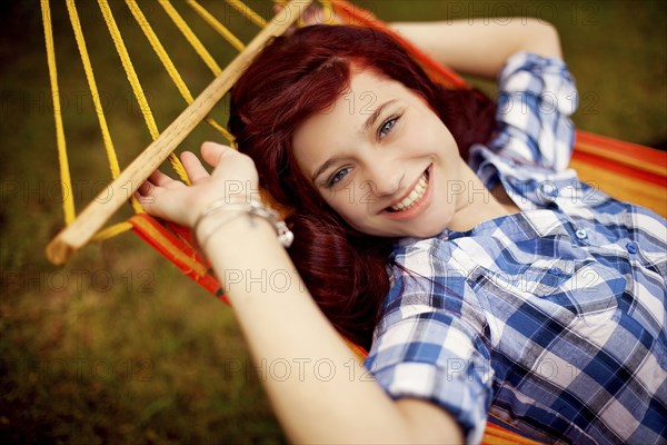 Smiling girl laying in hammock