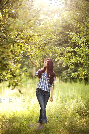 Girl admiring trees in rural field