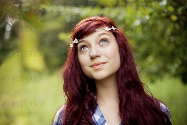 Girl wearing flower crown in rural field