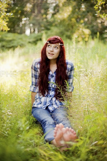 Girl wearing flower crown in rural field