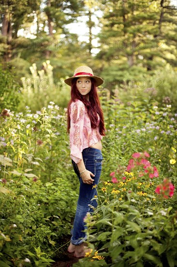 Girl wearing straw hat in garden