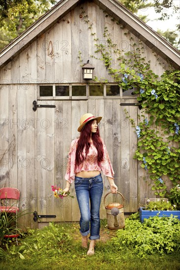 Gardener picking flowers in garden