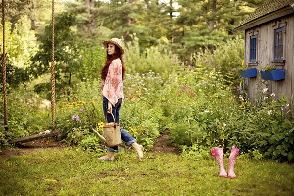 Gardener picking flowers in garden