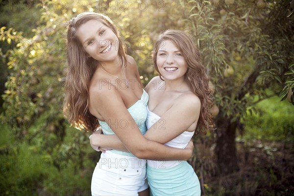 Caucasian women hugging in garden